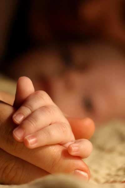 baby and mother  holding hand