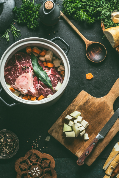 a pot of OssoBucco with veggies being prepared