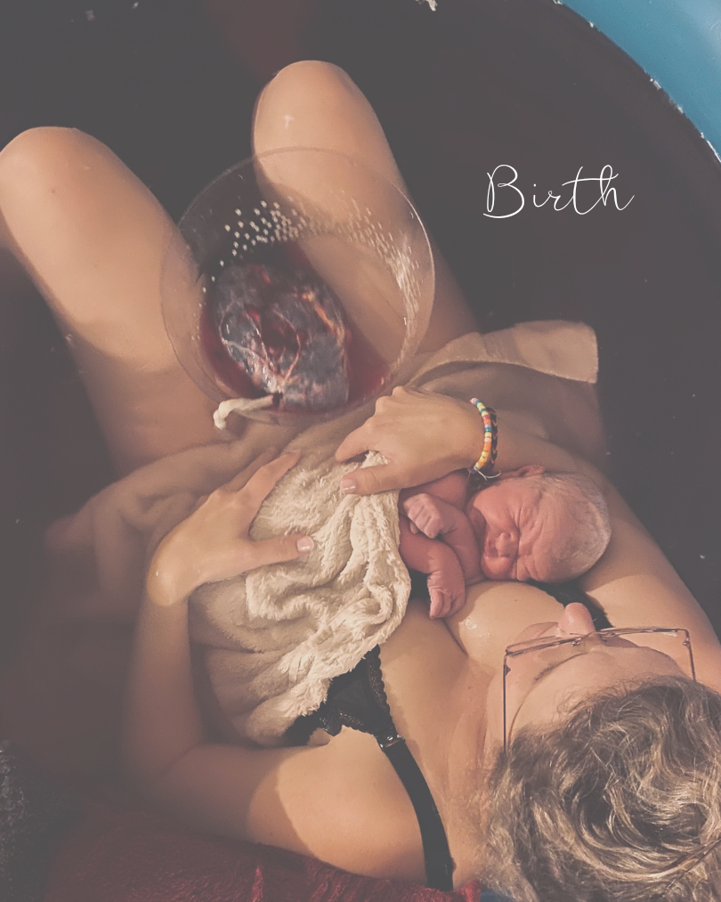 woman in a birthing pool with a placenta holding a baby